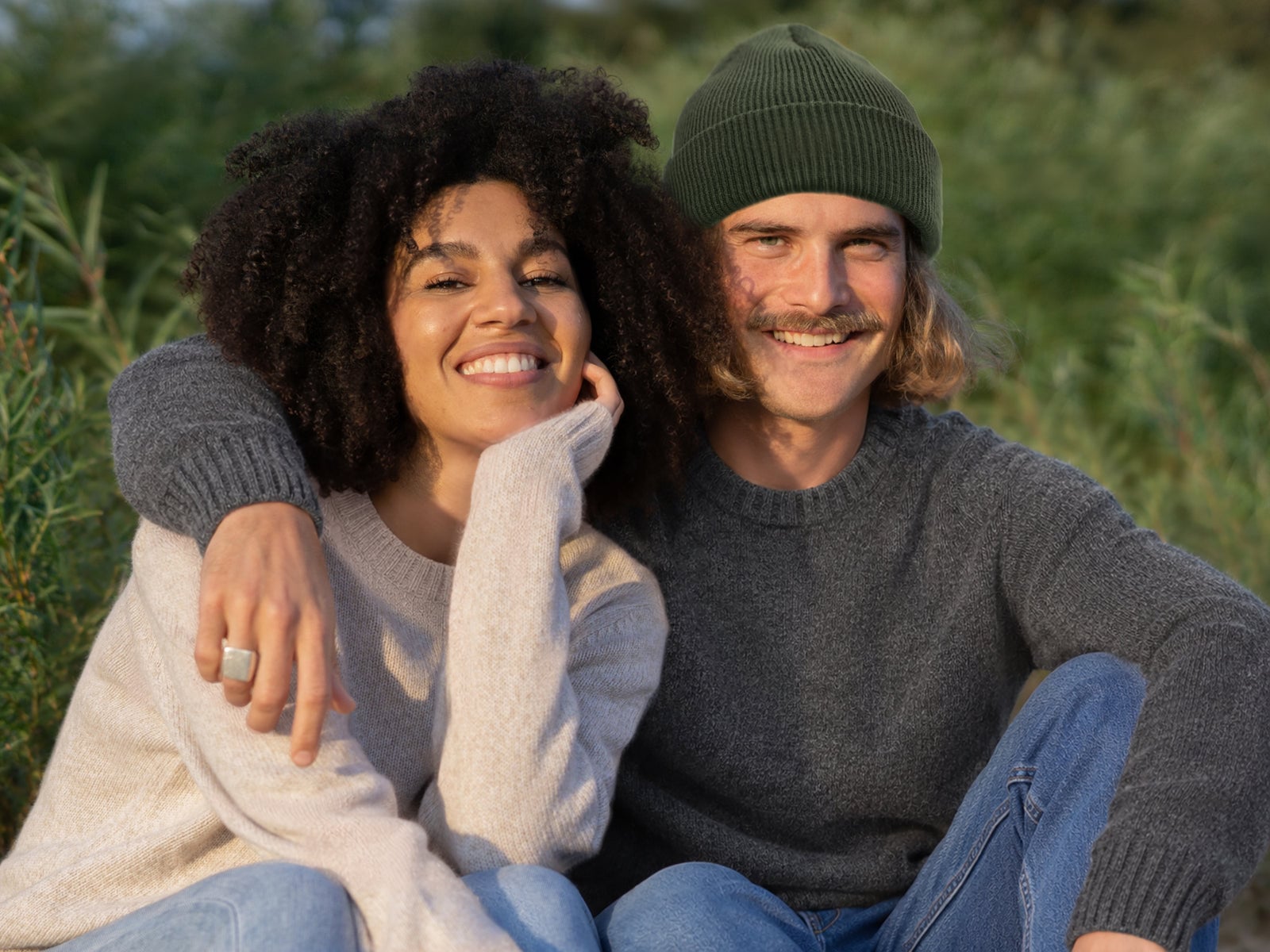 Two people wearing FUXBAU knit sweaters outdoors